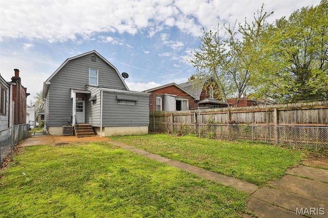4417 Wallace St, Saint Louis, MO 63116 - back of house with a gambrel roof, central AC unit, and entry steps