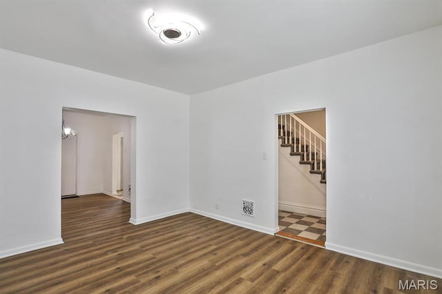 4417 Wallace St, Saint Louis, MO 63116 - empty room with wood finished floors, baseboards, and stairway