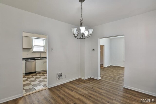 4417 Wallace St, Saint Louis, MO 63116 - unfurnished dining area with a sink, wood finished floors, a chandelier, and baseboards