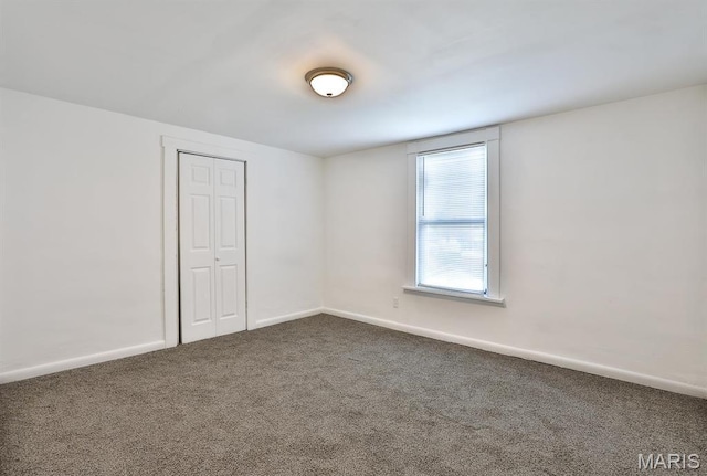 4417 Wallace St, Saint Louis, MO 63116 - spare room featuring dark carpet and baseboards