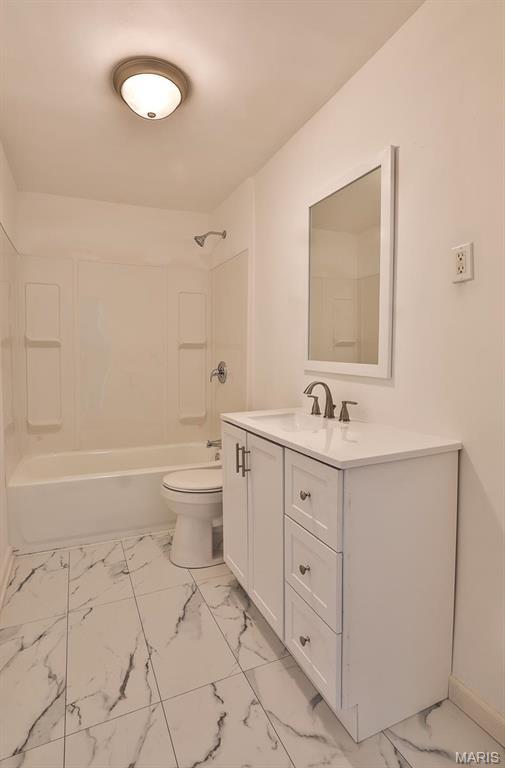 4417 Wallace St, Saint Louis, MO 63116 - bathroom featuring marble finish floors, vanity, toilet, shower / washtub combination, and baseboards