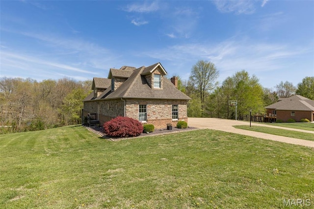 312 Oak Forest Dr, Jackson, MO 63755 - view of home's exterior featuring a yard, a chimney, and stone siding