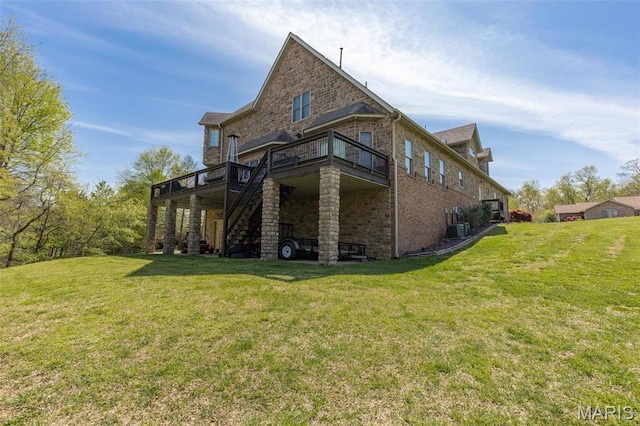 312 Oak Forest Dr, Jackson, MO 63755 - back of house featuring a wooden deck, stairs, brick siding, and a yard