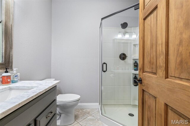 312 Oak Forest Dr, Jackson, MO 63755 - full bathroom featuring a shower stall, vanity, baseboards, and toilet