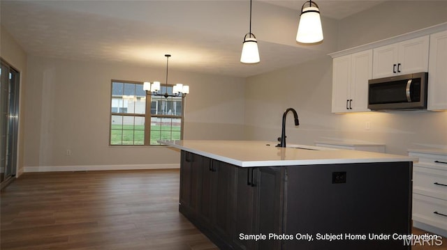 2028 Ravenel, Swansea, IL 62226 - kitchen with stainless steel microwave, a sink, wood finished floors, white cabinets, and a kitchen island with sink