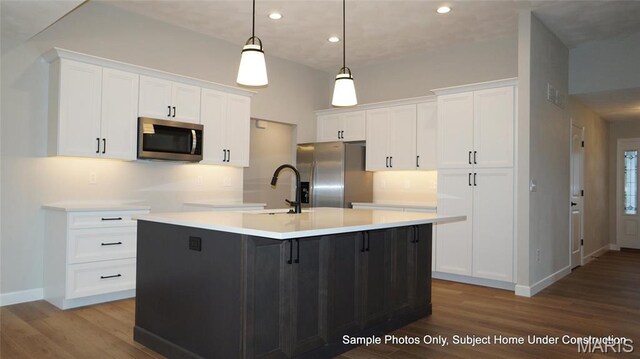 2028 Ravenel, Swansea, IL 62226 - kitchen with appliances with stainless steel finishes, an island with sink, wood finished floors, baseboards, and recessed lighting