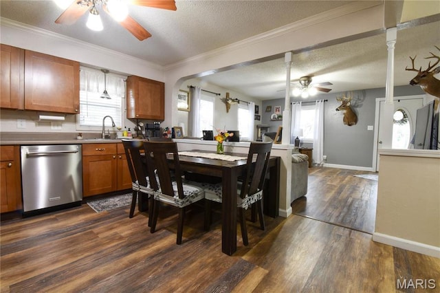 311 S Hibbard St, Staunton, IL 62088 - dining room featuring a ceiling fan, a textured ceiling, dark wood-type flooring, baseboards, and ornamental molding