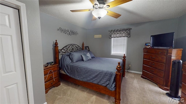 311 S Hibbard St, Staunton, IL 62088 - bedroom with light carpet, a textured ceiling, and ceiling fan