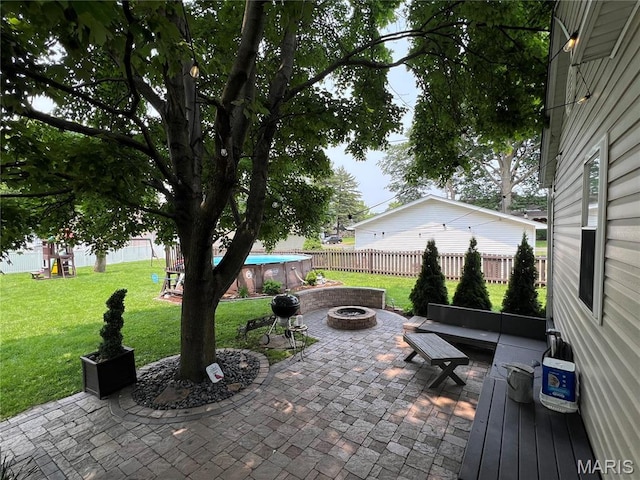 311 S Hibbard St, Staunton, IL 62088 - fenced backyard with an outdoor fire pit and a patio area
