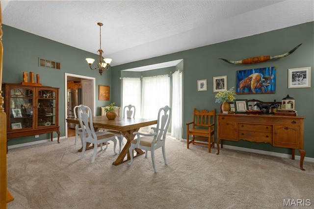 22 Whispering Oaks Dr, Washington, MO 63090 - carpeted dining room with a chandelier, a textured ceiling, and baseboards