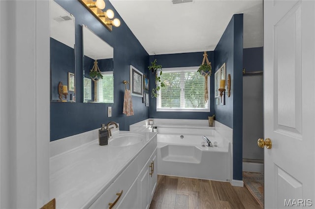 22 Whispering Oaks Dr, Washington, MO 63090 - bathroom featuring a bath, vanity, and wood finished floors