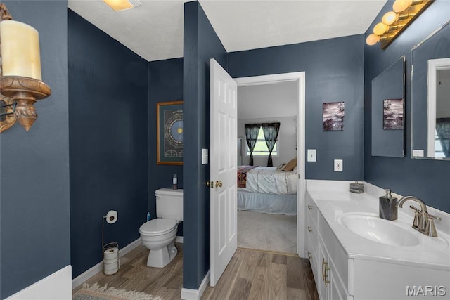 22 Whispering Oaks Dr, Washington, MO 63090 - ensuite bathroom with wood finished floors, toilet, and vanity