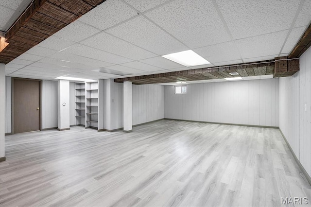 1115 Pinrun Dr, Ballwin, MO 63011 - below grade area with wood finished floors, baseboards, and a drop ceiling
