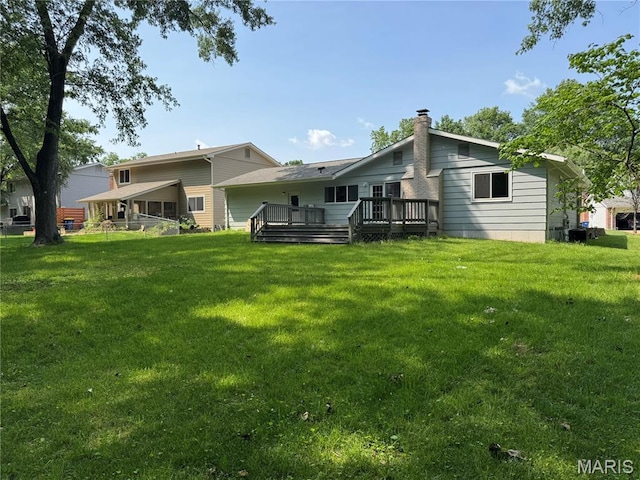 1115 Pinrun Dr, Ballwin, MO 63011 - rear view of house featuring a wooden deck, a yard, and a chimney