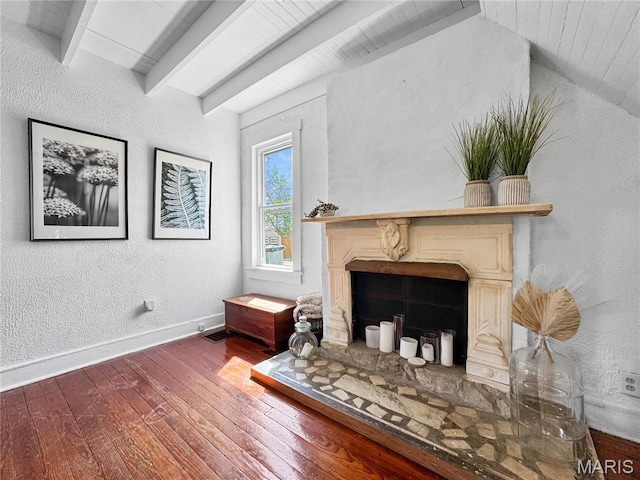 living area with hardwood / wood-style flooring, a fireplace, baseboards, wood ceiling, and a textured wall
