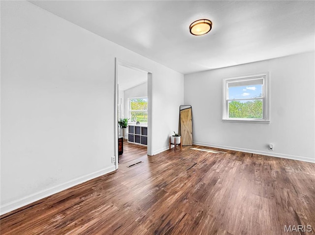 empty room featuring wood finished floors and baseboards