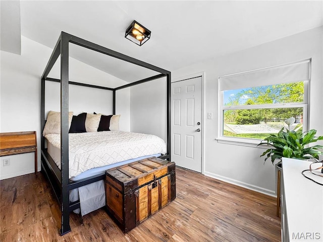 bedroom with wood finished floors and baseboards