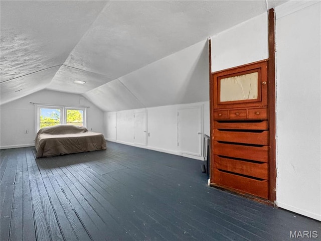 bedroom featuring vaulted ceiling, dark wood finished floors, and baseboards