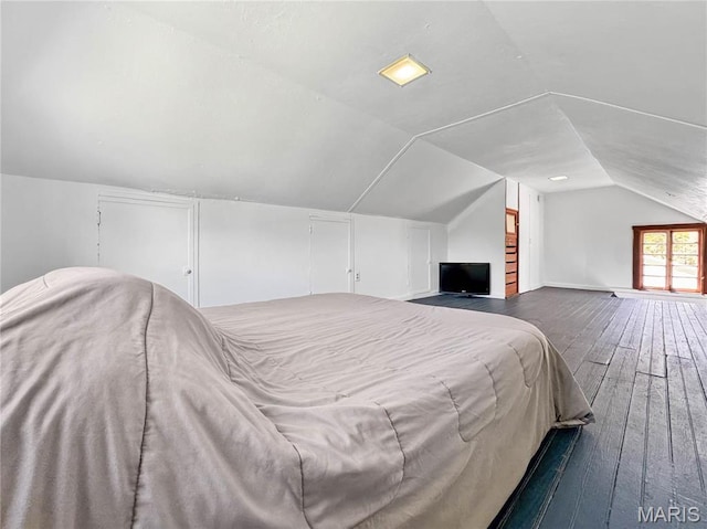 bedroom featuring vaulted ceiling and wood-type flooring