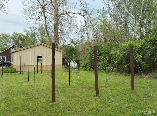 view of green lawn featuring an outbuilding and an outdoor structure