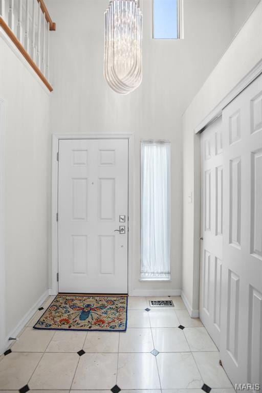 1709 Highview Circle Ct, Ballwin, MO 63021 - tiled entryway featuring a towering ceiling, a chandelier, and baseboards