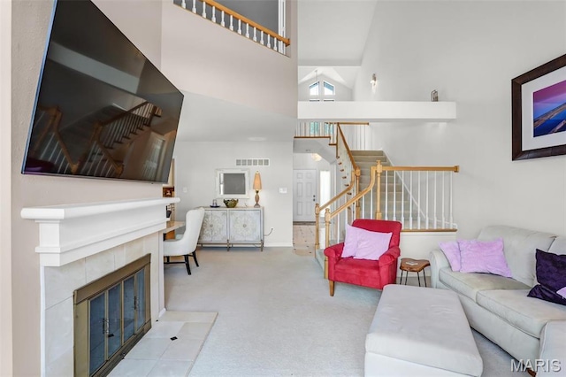 1709 Highview Circle Ct, Ballwin, MO 63021 - carpeted living area with a tiled fireplace, stairs, and a high ceiling