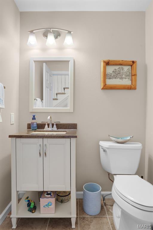1709 Highview Circle Ct, Ballwin, MO 63021 - half bath featuring baseboards, vanity, tile patterned flooring, and toilet
