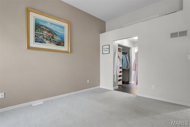 1709 Highview Circle Ct, Ballwin, MO 63021 - unfurnished bedroom featuring carpet, a spacious closet, baseboards, and a closet
