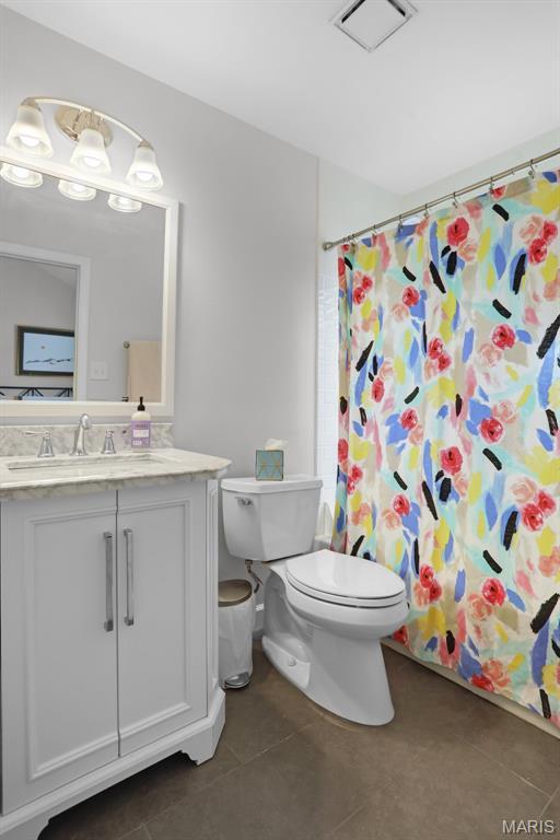 1709 Highview Circle Ct, Ballwin, MO 63021 - full bath with tile patterned floors, toilet, vanity, and a shower with shower curtain