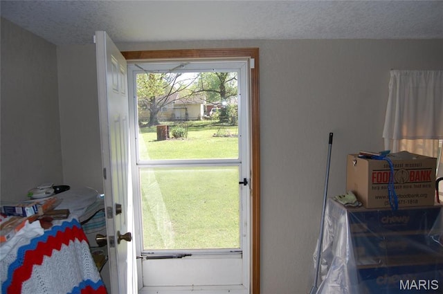 doorway featuring a textured ceiling
