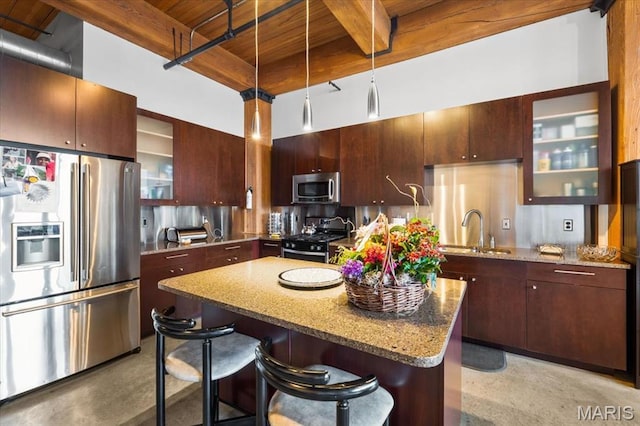 kitchen featuring appliances with stainless steel finishes, wooden ceiling, a sink, a center island, and beamed ceiling