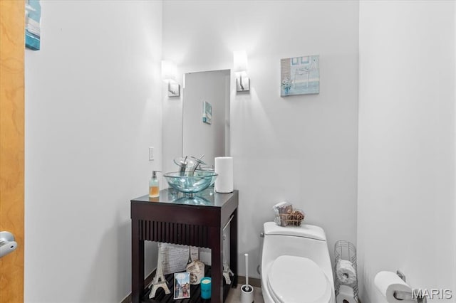 half bathroom featuring toilet and vanity