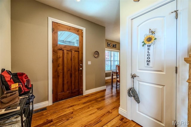 entrance foyer with wood finished floors and baseboards