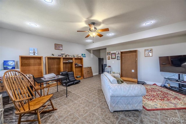 living area with ceiling fan, recessed lighting, baseboards, an office area, and a textured ceiling
