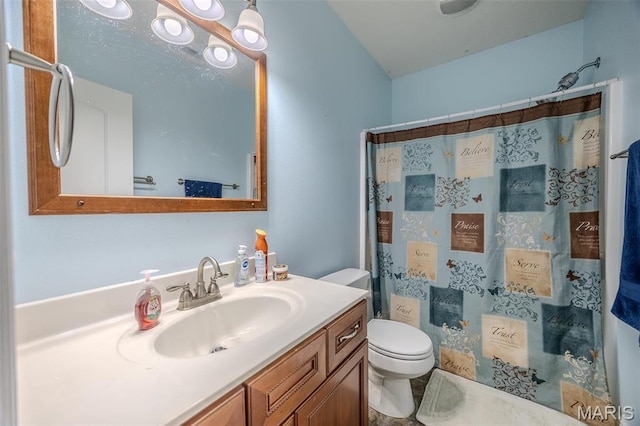 bathroom with toilet, vanity, and a shower with shower curtain