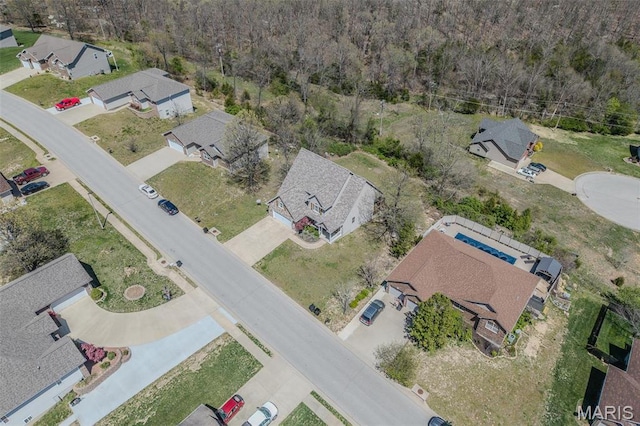aerial overview of property's location with a heavily wooded area and nearby suburban area