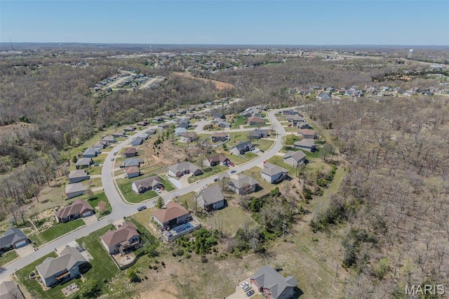 aerial view of property and surrounding area featuring nearby suburban area