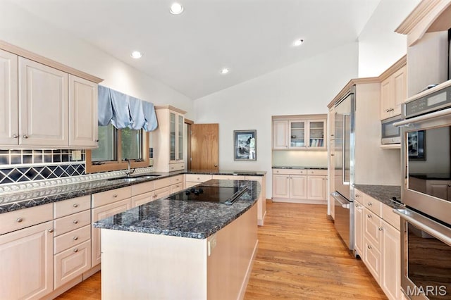 1406 W Adams, Kirkwood, MO 63122 - kitchen featuring built in appliances, a sink, lofted ceiling, light wood-type flooring, and a center island