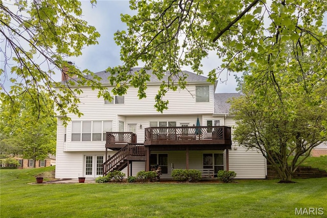 back of house featuring a deck, a lawn, stairway, a shingled roof, and a patio