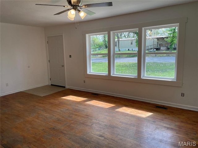 903 S Oak St, Salem, MO 65560 - unfurnished room featuring healthy amount of natural light, baseboards, wood finished floors, and ceiling fan