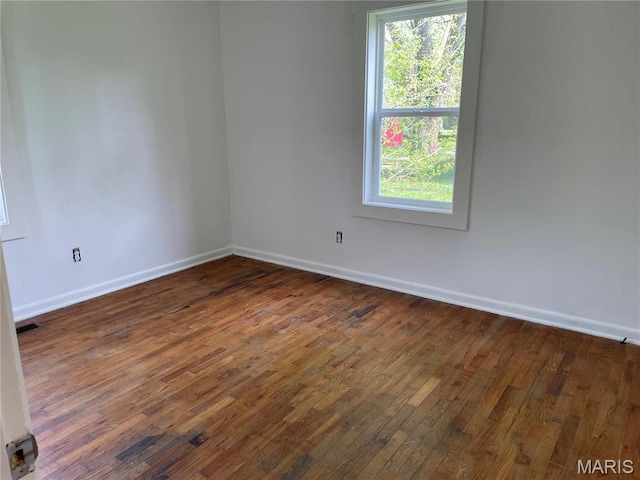 903 S Oak St, Salem, MO 65560 - spare room featuring baseboards, dark wood finished floors, and plenty of natural light