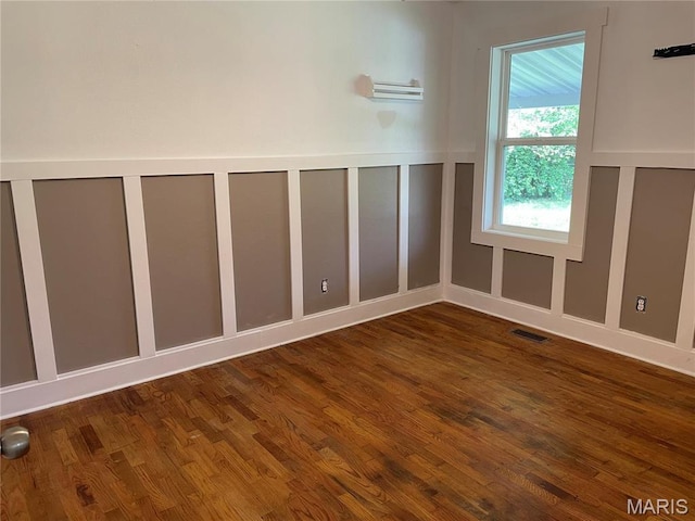 903 S Oak St, Salem, MO 65560 - unfurnished room with wood finished floors and a decorative wall