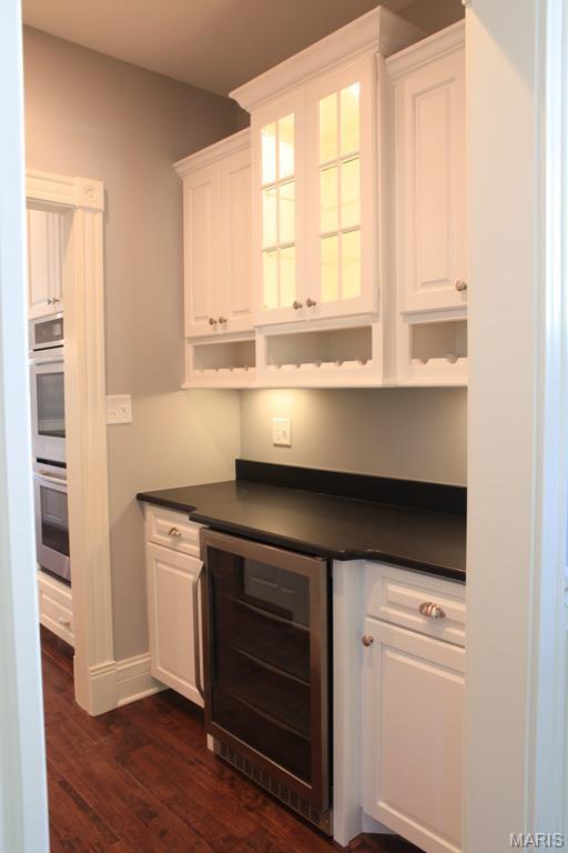 420 W Rose Hill, Saint Louis, MO 63122 - bar featuring beverage cooler, dark wood-style flooring, and double oven