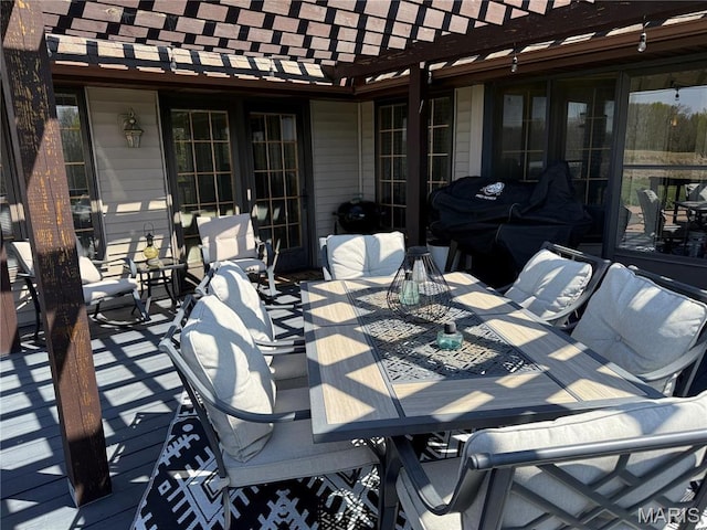view of patio / terrace with outdoor dining space, a pergola, and french doors