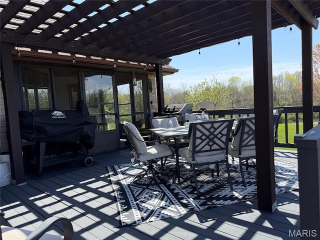 wooden deck with a pergola and outdoor dining space