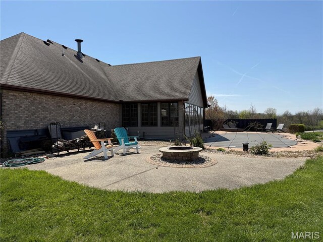 view of patio with a fire pit and a covered pool
