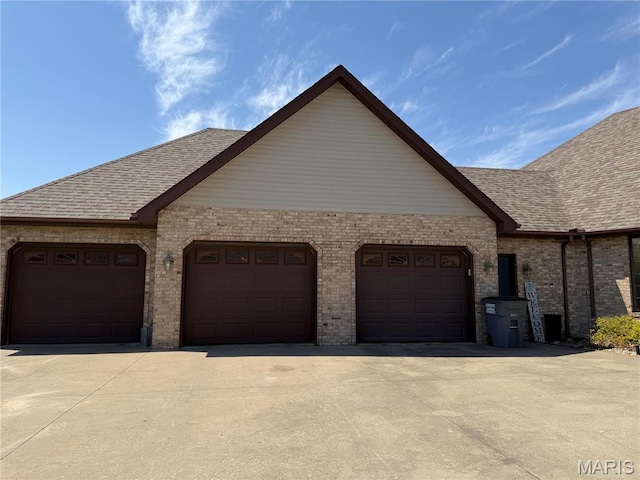 garage featuring concrete driveway