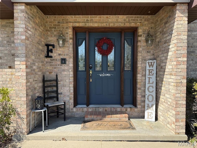 property entrance with brick siding
