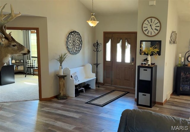entrance foyer featuring wood finished floors and baseboards