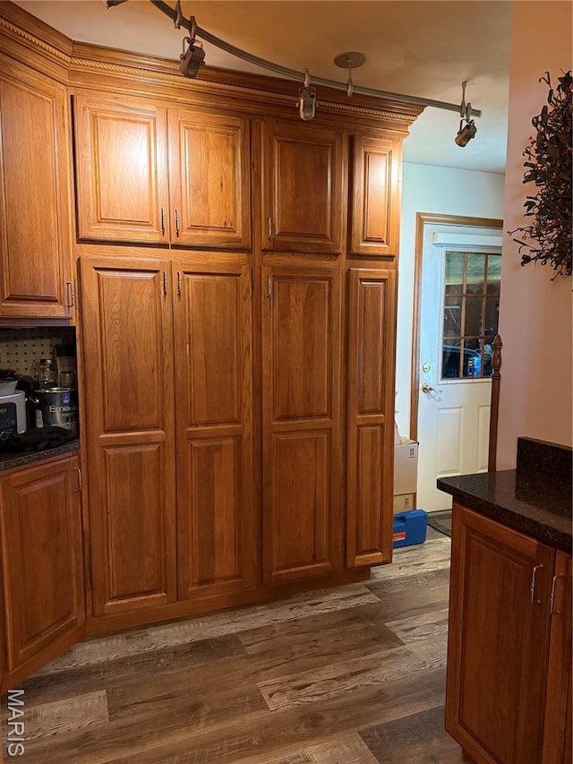 kitchen featuring dark wood-type flooring and brown cabinets